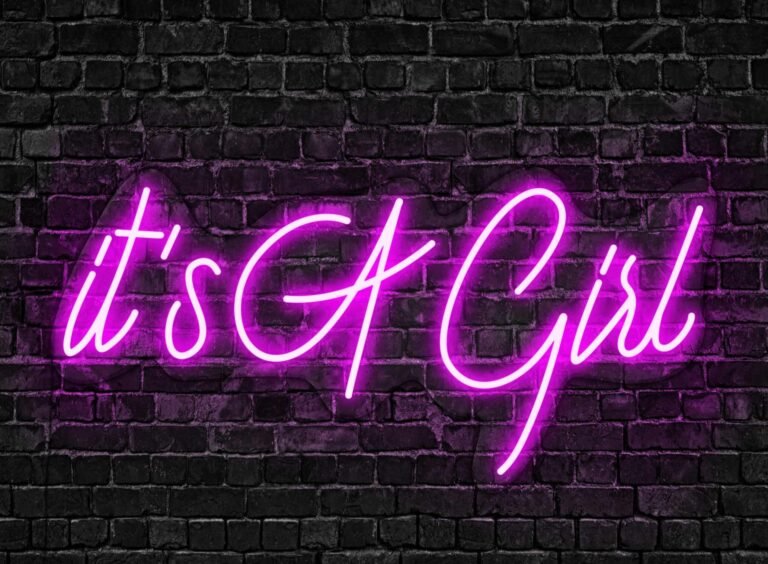 “It’s a Girl” neon sign.